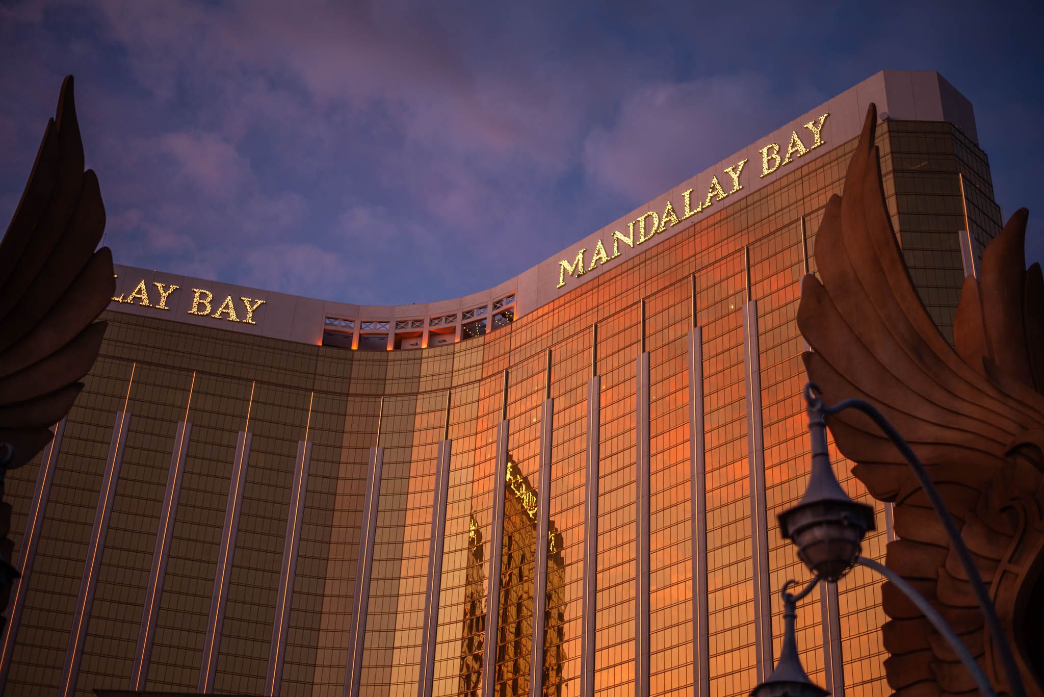 Towering building with lite signage saying 'Mandalay Bay Hotel'