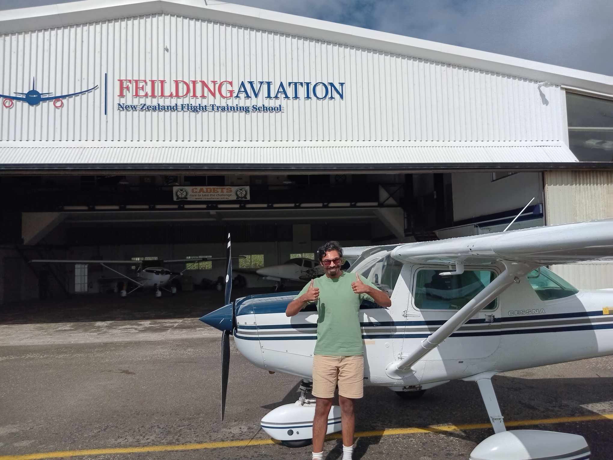 Person posing in front of a plane